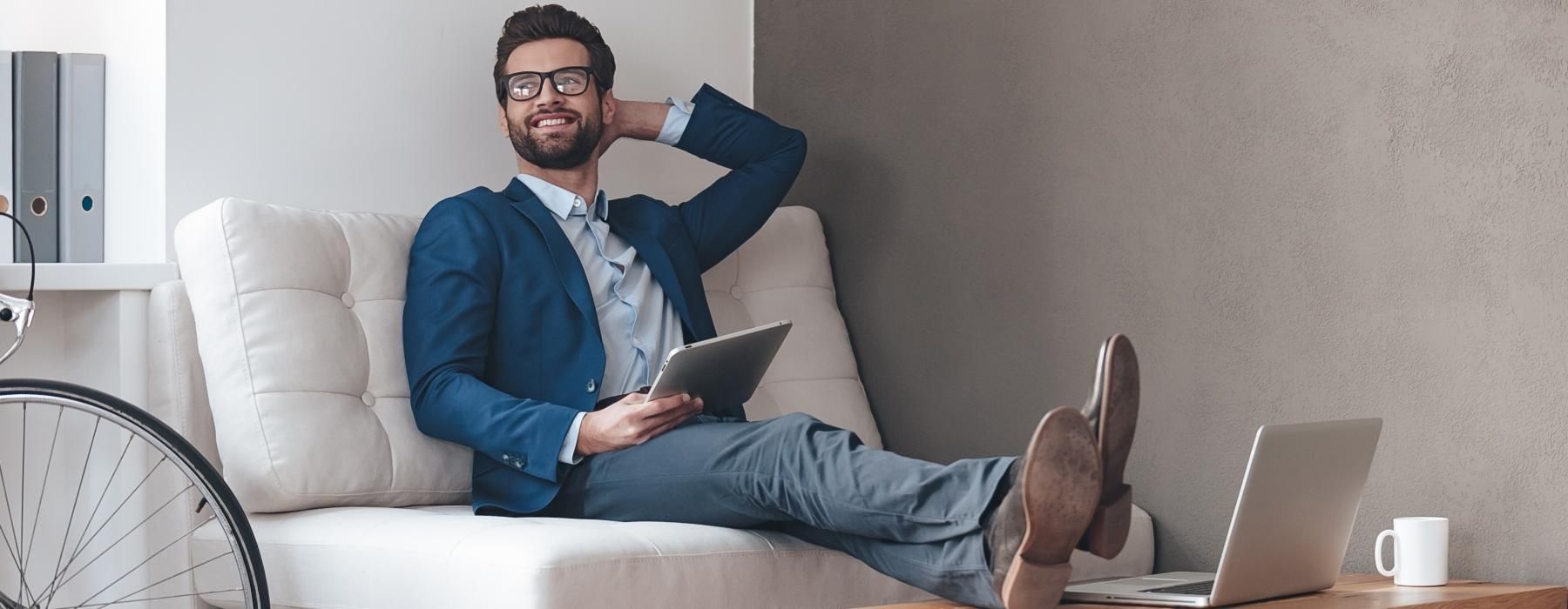 a person sitting on a couch with a laptop